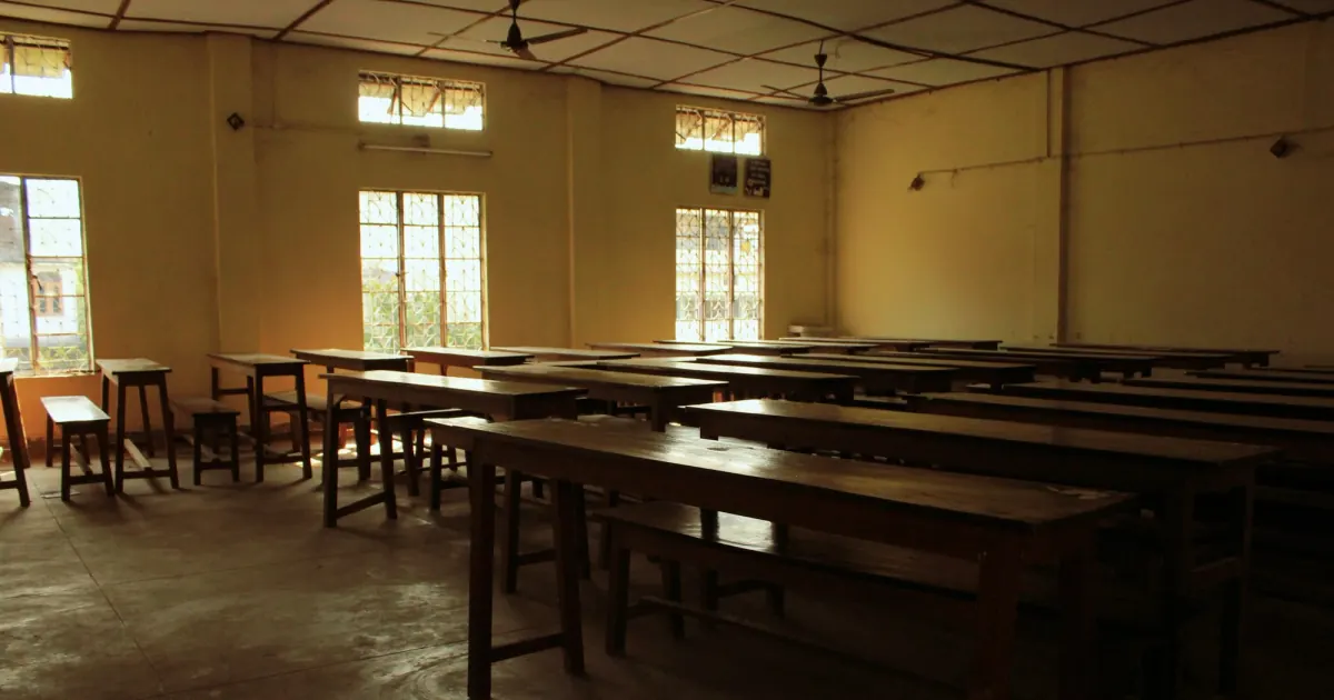 Empty classroom tables and chairs in India; a contextual photograph for service continuity.